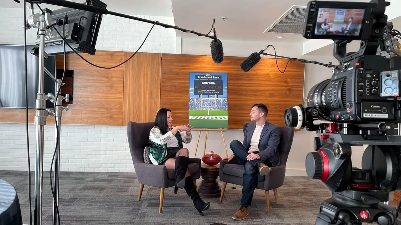 Two-camera interview set with professional lighting and overhead dialogue microphones at a client location