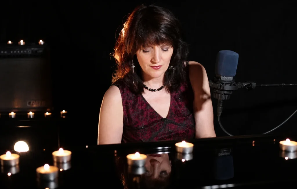Annie Moscow performing at piano